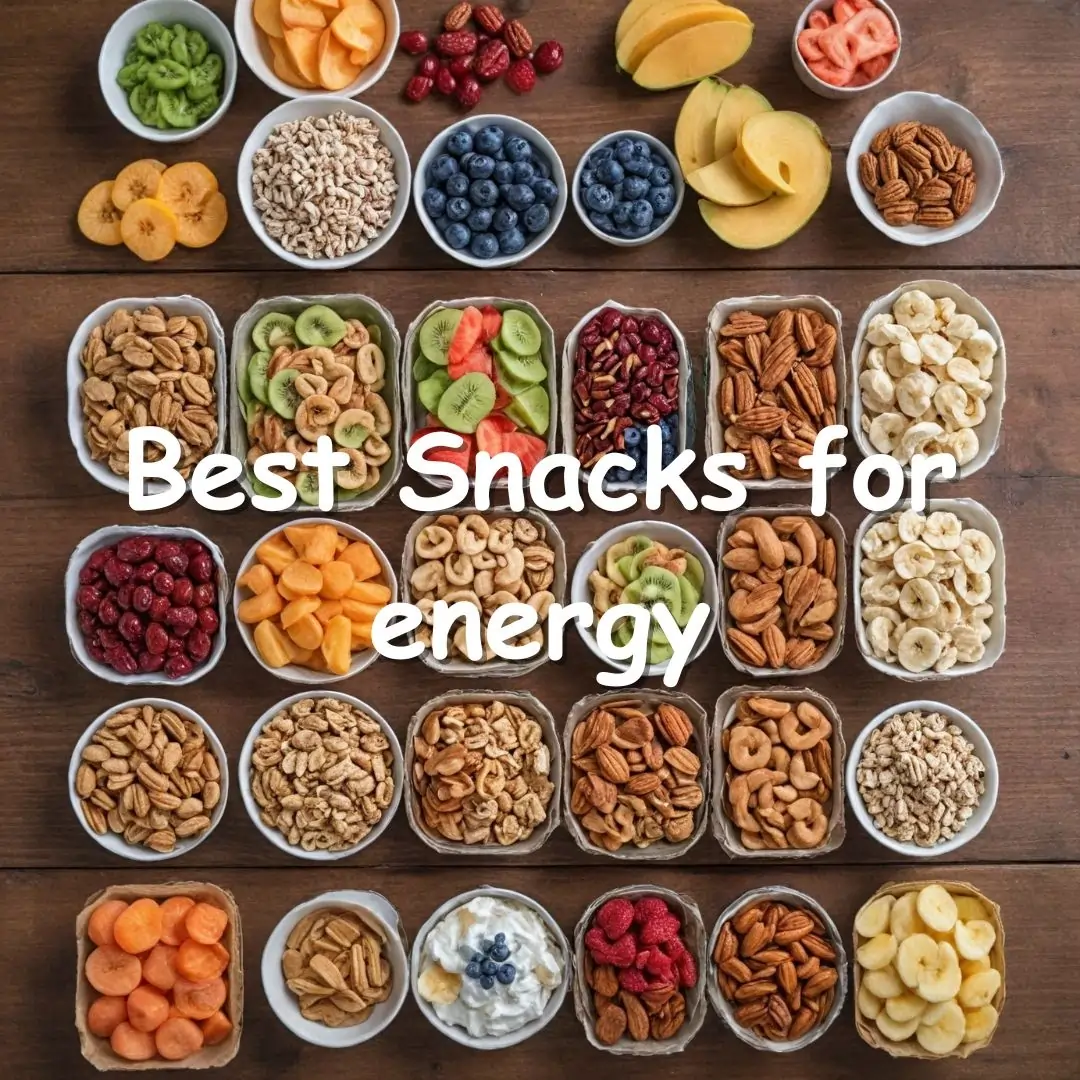 A selection of healthy snacks including fresh fruit, mixed nuts, whole-grain crackers, and hummus on a kitchen counter.